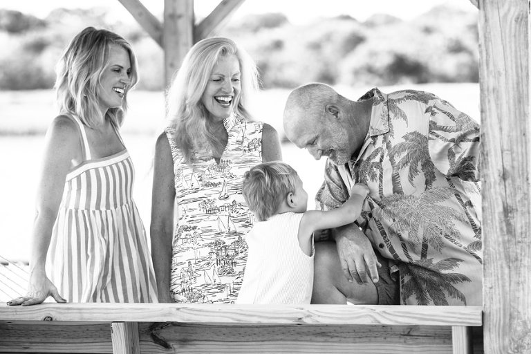 toddler giggles with his grandfather on Charleston barrier island