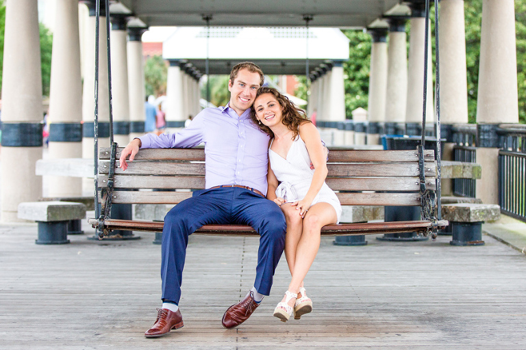 Engaged couple swings at Charleston's Waterfront Park